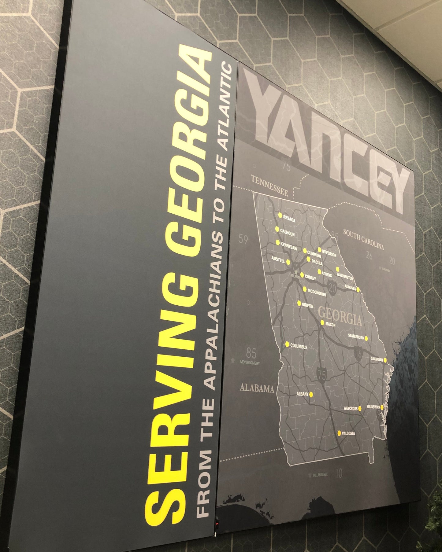 Territory Map for Caterpillar Dealer Showroom on a wall with 'Serving Georgia' text above it, in an indoor setting.