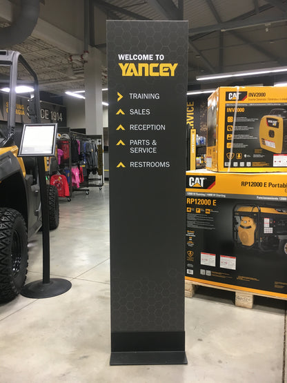 Branded free-standing stanchion with product packaging in the background