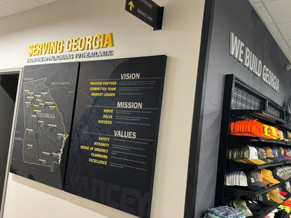 Territory Map for Caterpillar Dealer Showroom on a wall with 'Serving Georgia' text above it, in an indoor setting.