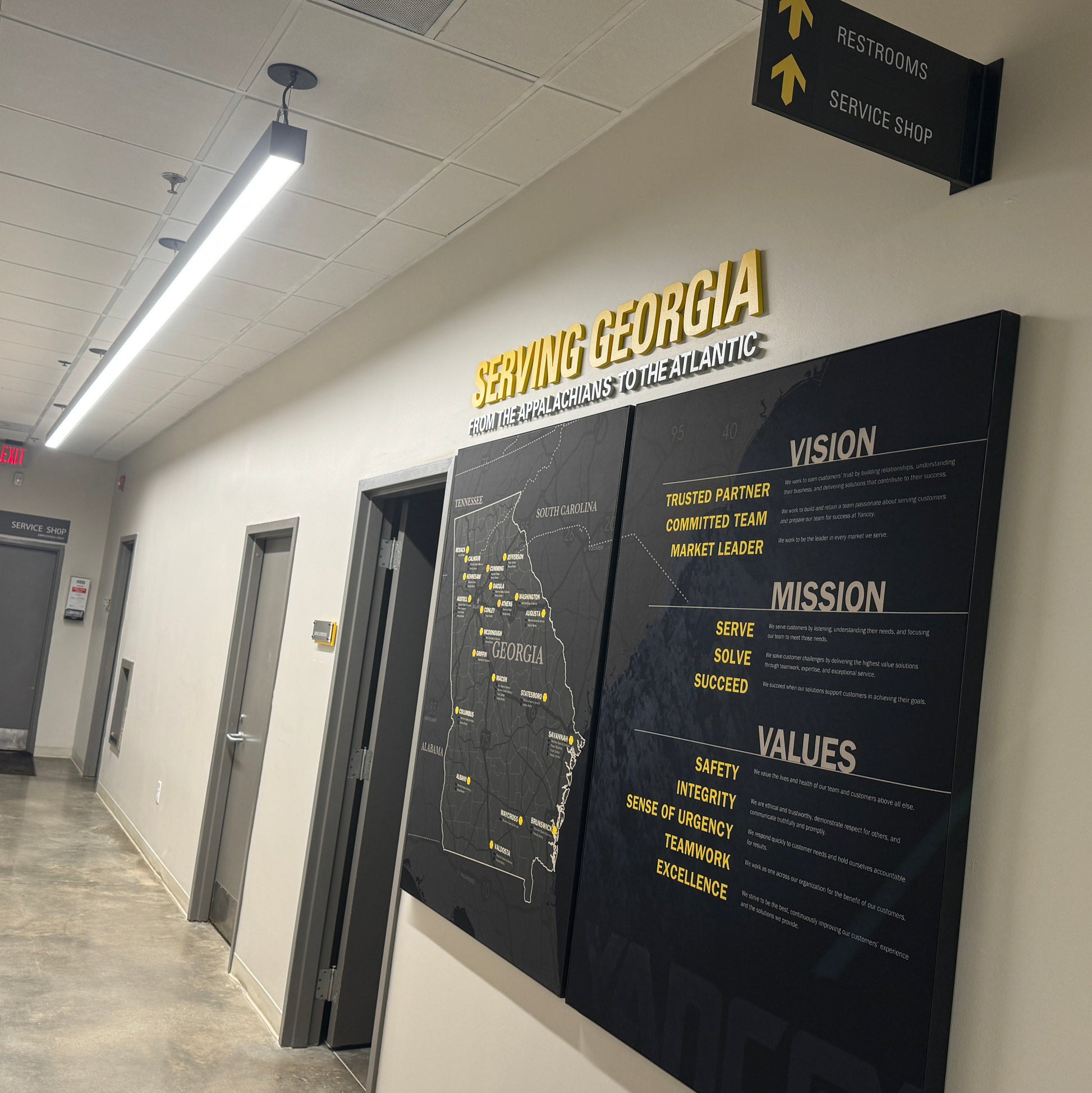 Territory Map for Caterpillar Dealer Showroom on a wall with 'Serving Georgia' text above it, in an indoor setting.