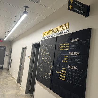 Territory Map for Caterpillar Dealer Showroom on a wall with 'Serving Georgia' text above it, in an indoor setting.