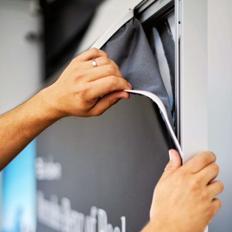 Person installing  a Silicon Edge Graphic