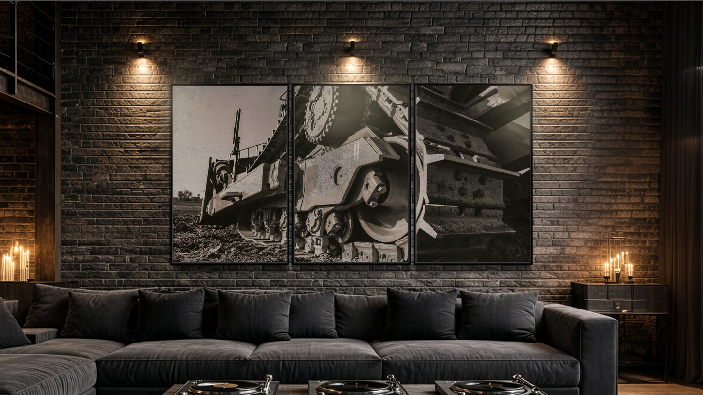 Modern living room with dark gray sectional sofa, wooden coffee table, and brick wall with framed Caterpillar undercarriage art.