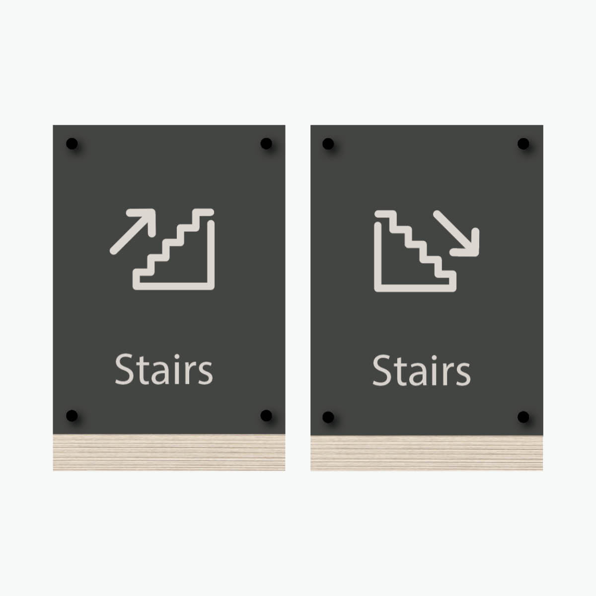 Two signs with the word 'Stairs' printed on them, featuring an icon of stairs on each, wall-mounted hardware.