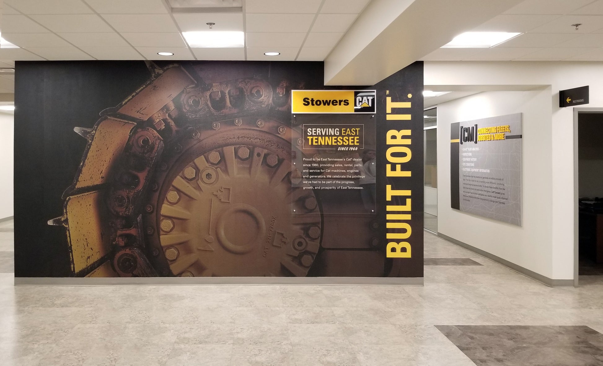 A wall mural featuring a close-up of a CAT undercarriage.